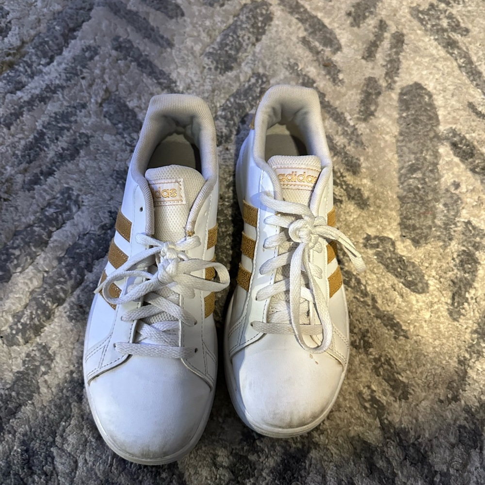White and gold adidas.